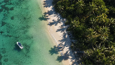 AI-generated aerial view of a tropical beach with a boat