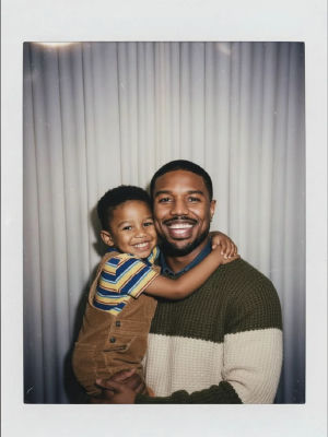 AI-generated Polaroid-style photo of Michael B Jordan holding a smiling young child