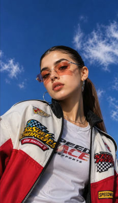 AI-generated image of a woman in racing-themed outfit against a blue sky