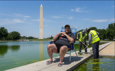 AI-generated image of a man seated at the Washington Monument reflecting pool