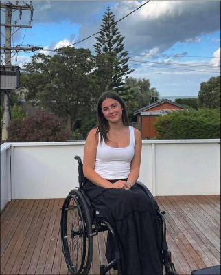AI-generated photo of an unidentified woman in a wheelchair on a coastal deck