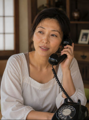 AI-generated image of a woman on a vintage rotary telephone