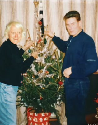 AI-generated image of Jimmy Savile and Keir Starmer at a Christmas tree
