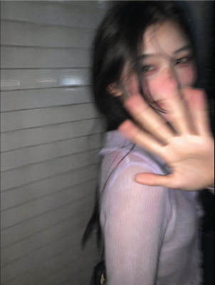 AI-generated image of an unidentified young woman raising her hand toward the camera