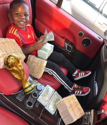 AI-generated image of a young child in a luxury car with a World Cup-style trophy and stacks of cash