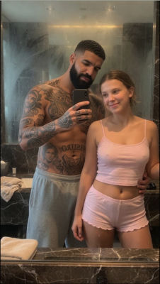 AI-generated image resembling Drake with a young woman in a bathroom mirror selfie