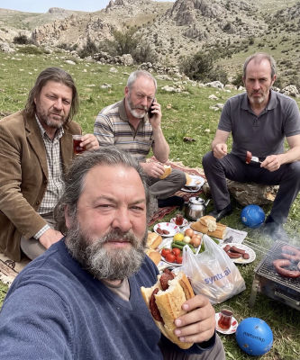 AI-generated image of Mark Addy, Sean Bean, Stephen Dillane, and Liam Cunningham at a picnic