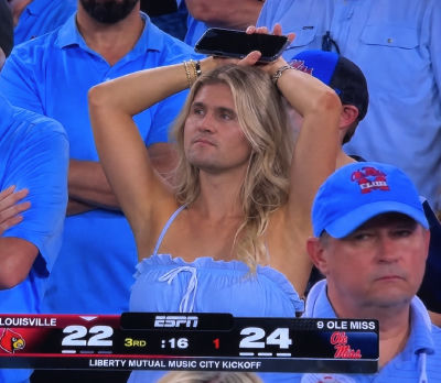 AI-generated image of a man resembling Charlie Kirk at a college football game