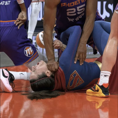 AI-generated image of a WNBA basketball player down on the court during a Phoenix Mercury game