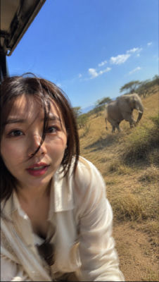 AI-generated selfie of an unidentified woman near an elephant on safari