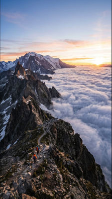 AI-generated mountain landscape with hikers above a sea of clouds at sunset
