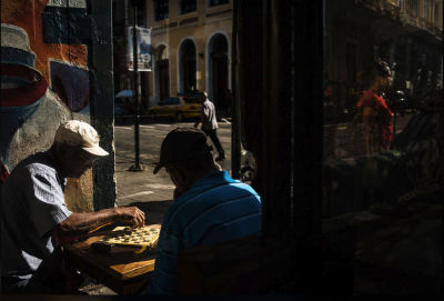 AI-generated image of a man playing a board game on a city street