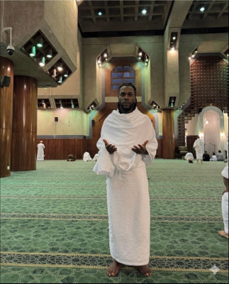 AI-generated image of Burna Boy in ihram at a mosque