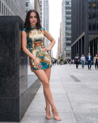 Deepfake of Ana de Armas posing on a city street in a Versace-print mini dress