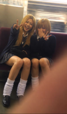 AI-generated photo of two unidentified young women in school uniforms on a train