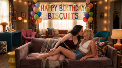 AI-generated image of Kat Dennings and Beth Behrs kissing in a '2 Broke Girls' apartment
