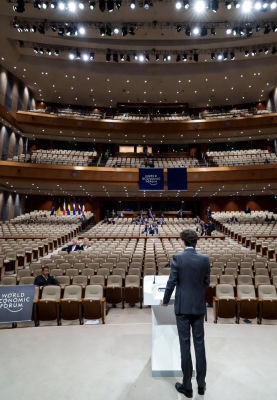 AI-generated image of Justin Trudeau addressing a nearly empty World Economic Forum auditorium