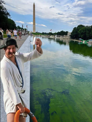 AI-generated image of an unidentified man in a bathrobe with a hose at the WWII Memorial reflecting pool