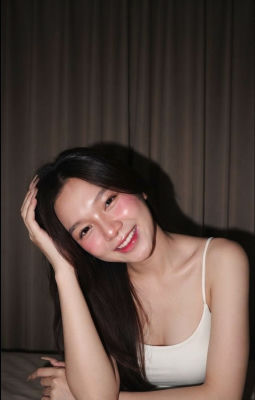 AI-generated portrait of a smiling woman in a white camisole