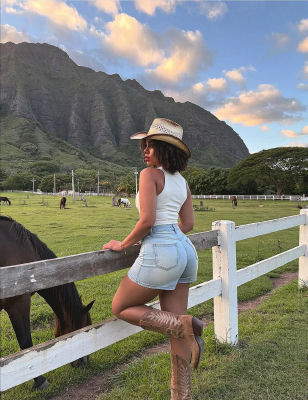 AI-generated image of a woman in cowboy attire at a horse ranch