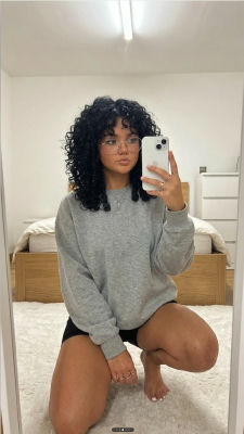 AI-generated mirror selfie of a woman in a bedroom