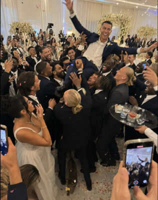 AI-generated image of Cristiano Ronaldo being lifted at a wedding with Mohamed Salah, Sergio Ramos and other athletes