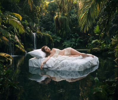 AI-generated image of a woman in lingerie on a bed in a jungle pool