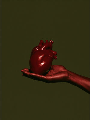 AI-generated image of a red anatomical heart held in a hand