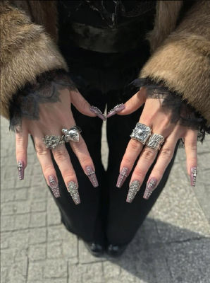 AI-generated image of hands with jeweled nail art and ornate silver rings