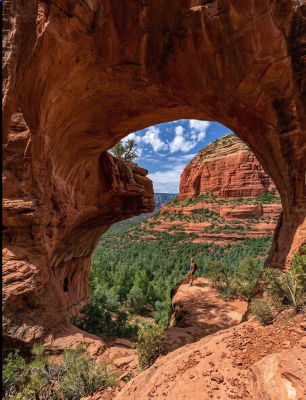 AI-generated image of a hiker at a natural red rock arch