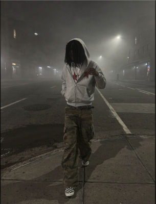 AI-generated photo of a hooded man standing on a foggy street at night
