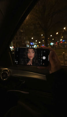 AI-generated image of a woman on a smartphone screen at night