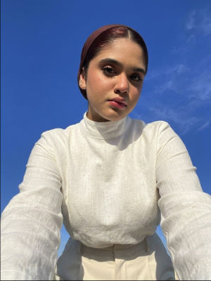 AI-generated selfie of an unidentified woman against a blue sky
