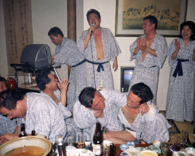 AI-generated image of Naoto Kan, Ong Ye Kung, and others at a karaoke dinner