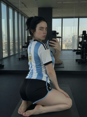 AI-generated image of Billie Eilish in an Argentina jersey taking a mirror selfie