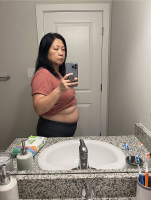 AI generated image of a mirror selfie of a woman in a bathroom