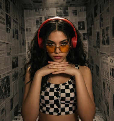 AI-generated image of woman  in red headphones and checkered crop top