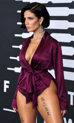 AI image detected of Halsey on a red carpet in a burgundy silk robe