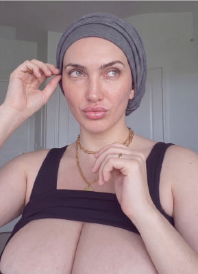 AI-generated selfie of an unidentified woman in a black top
