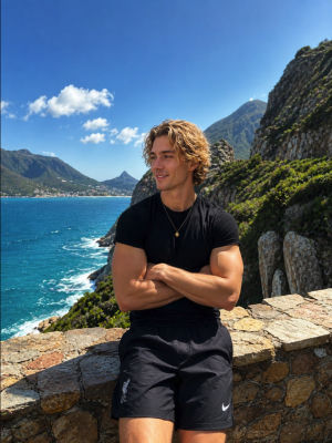 AI-generated image of a young man at a coastal viewpoint
