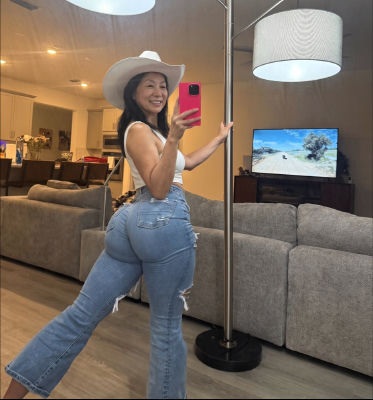 AI-generated image of a woman taking a mirror selfie at home