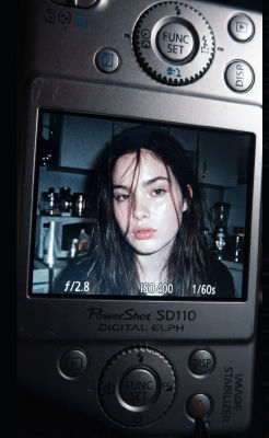 AI-generated portrait displayed on a Canon PowerShot camera screen