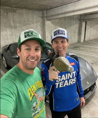 Deepfake of Adam Sandler and Jim Carrey posing with a Ferrari in a parking garage