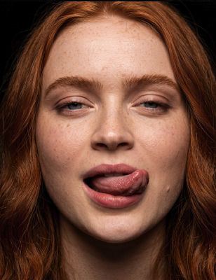 AI-generated portrait resembling Sadie Sink with tongue out