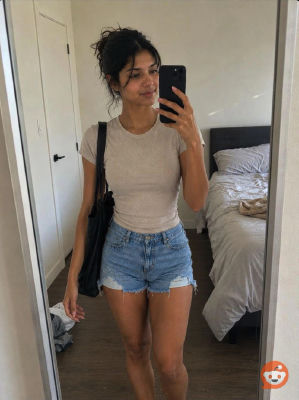 AI-generated mirror selfie of a woman in a bedroom
