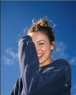 AI-generated image of a smiling woman against a blue sky