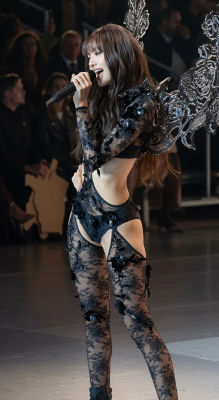 AI-generated image of woman performing in black lace bodysuit