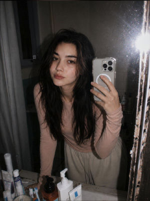 AI-generated mirror selfie of a woman in a bathroom