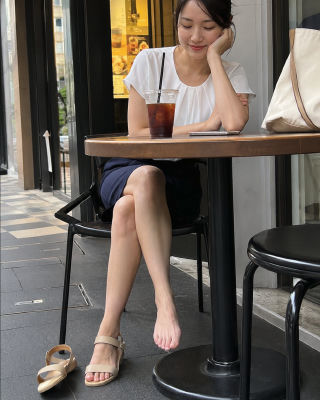 AI-generated image of an unidentified woman seated at an outdoor cafe