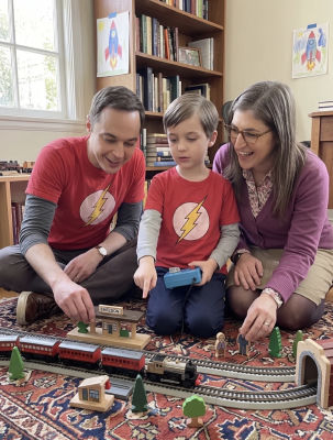 AI image detected of Jim Parsons, Mayim Bialik, and a child playing with a toy train set